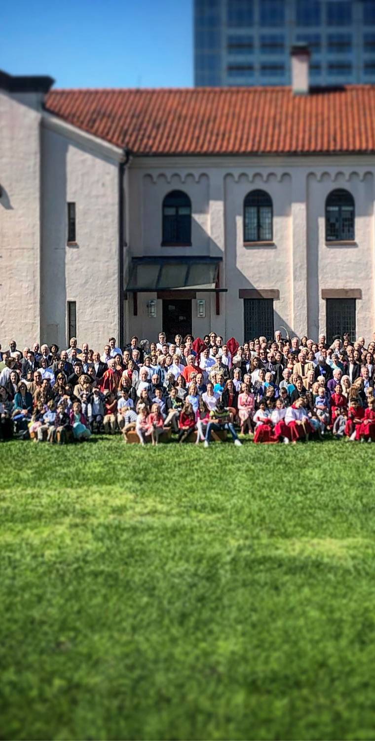A large community gathered on a lawn